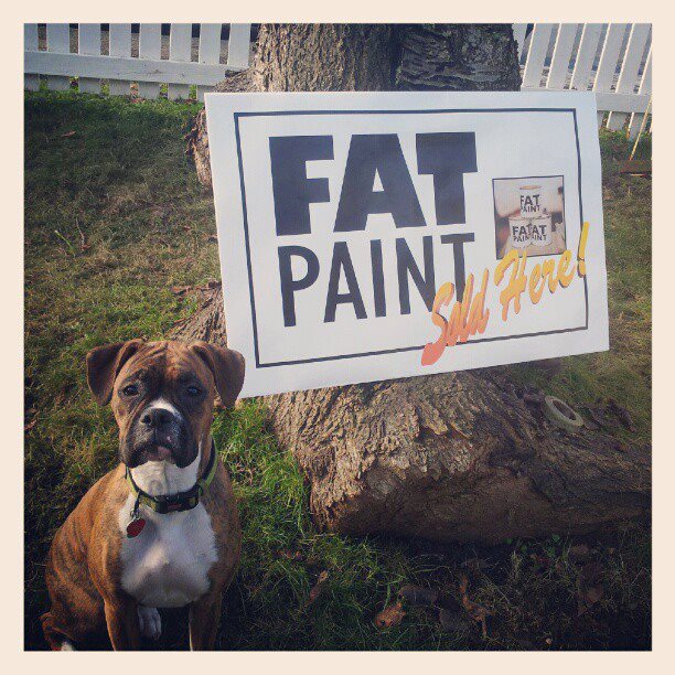 Our shop dog Juno standing by one of our first retailers proudly displaying they sell FAT Paint!